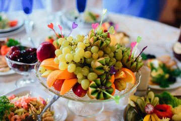 fruit plate with fresh orange, grapes, kiwi and Apple