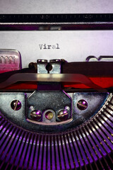 Vintage typewriter with the word Viral printed on a sheet of paper social media concept