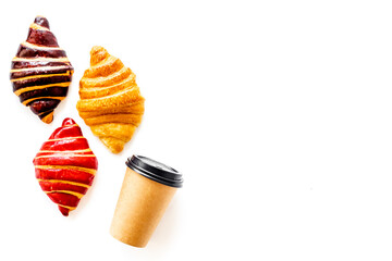 Set of coffee with croissants - chocolate, berry, classic - on white top view