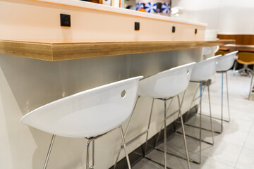 The interior of the waiting room. A row of chairs near the bar shelf.