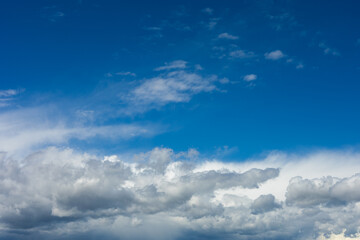 Beautiful blue sky background at daylight with white cumulus clouds.