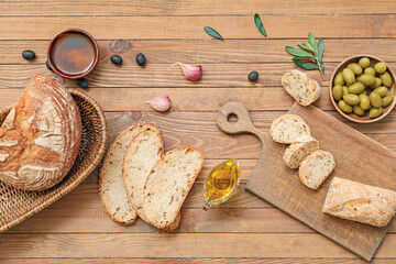 Composition with tasty olive oil and bread on wooden background