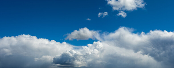 Beautiful blue sky background at daylight with white cumulus clouds. Backgroud panoramic banner.