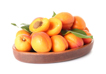 Plate with tasty ripe apricots on white background