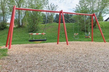 Corona virus quarantine lockdown prohibit playground swings. Closure by barrier tape. Covid-19...
