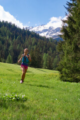 Female trail runner in grass landscape, Switzerland