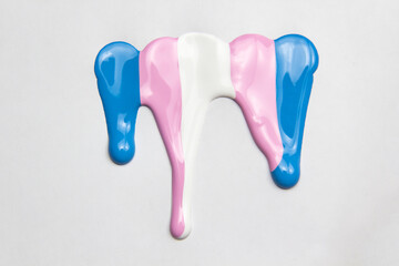 The paint colors of transgender flag - blue, pink,white. Conceptual illustration lesbian, gay, bisexual, and transgender. Colorful acrylic paint dripping on white background, copy space for text