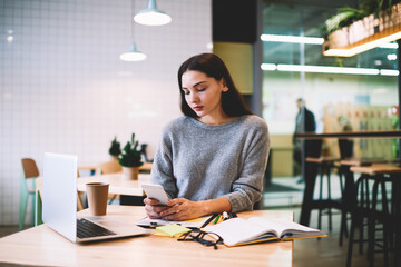 Young skilled female freelancer reading feedback from CEO  sending new task  of creating advertising content for social networks and popular website to increase client’s interest to service production