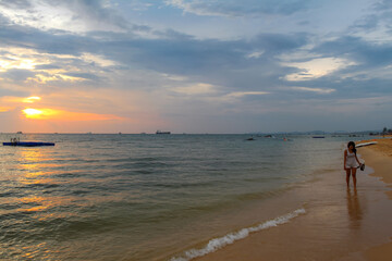 An Asian women strolling on Ba Keo beach at sunset, Phu Quoc, Vietnam