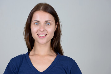 Fototapeta premium Face of young beautiful woman looking at camera