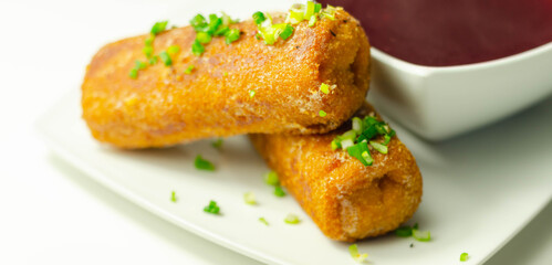 Delicious croquettes with sauerkraut and mushrooms served with hot red borscht