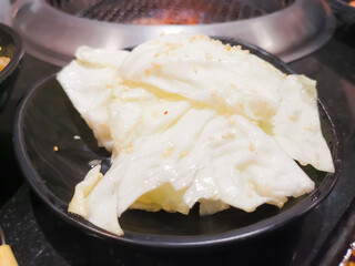 Close up of Fried cabbage with fish sauce and White sesame seeds