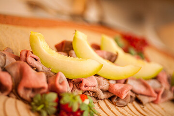 Mediterranian, Italian appetizers, Slices of cantaloupe melon with prosciutto parma ham. High...