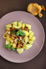 Dish with fried mushrooms and potatoes seasoned with sauce