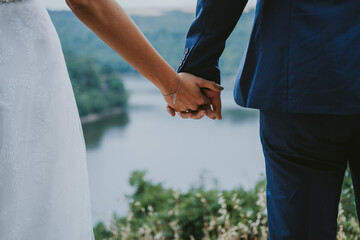 bride and groom holding hands