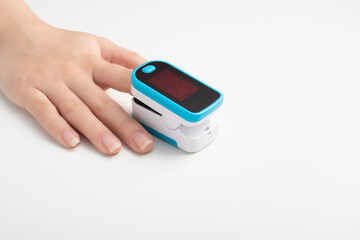 Saturation of hemoglobin of blood with oxygen. Female finger in a pulse oximeter
