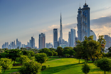 Dubai skyline across a green park