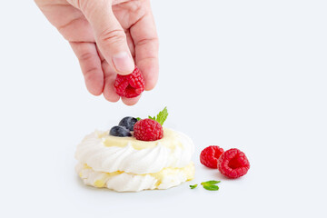 mini Pavlova dessert with raspberries and blueberries on the table