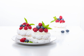 mini Pavlova dessert with raspberries and blueberries on the table