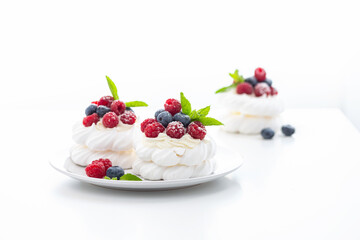 mini Pavlova dessert with raspberries and blueberries on the table