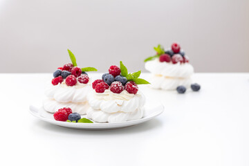 mini Pavlova dessert with raspberries and blueberries on the table