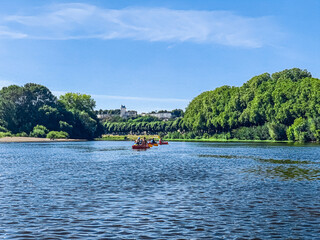 People kayaking on the famous Loire river with the Chinon city on background