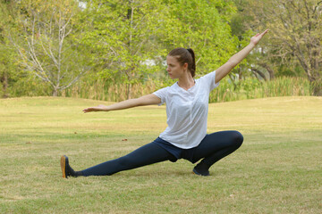 Fototapeta na wymiar Young beautiful woman exercising at the park outdoors