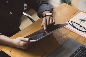 Cropped shot of young female hands using a digital tablet. Technology concept
