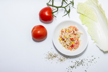 Fresh salad with salmon, tomatoes and Peking cabbage. Top view on white background