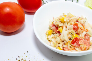Fresh salad with salmon, tomatoes and Peking cabbage. Top view on white background