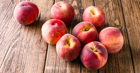 Fresh, tasty peaches on a wooden background. Long banner