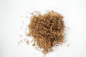 close up heap of tobacco on white background from overhead view.