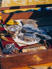 treasure chest with coins and silver objects at flea market