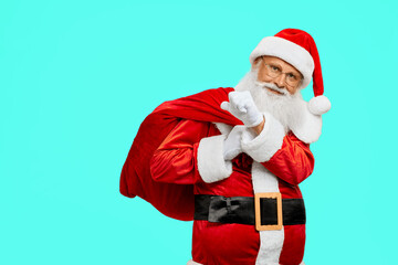 Fototapeta na wymiar Smiling Santa Claus holding bag with presents.