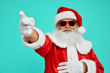 Man in Santa Claus costume pointing away.