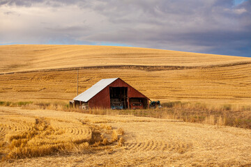 A red barn in the fall season in the palouse wheat country in southeastern Washington.