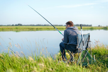 A fisherman is fishing on the lake.