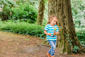 Toddler girl running in forest