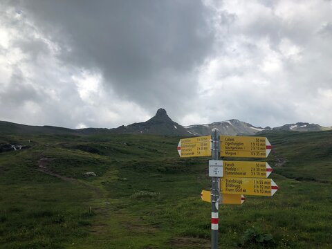 Imposing Spitzmeilen peak from Spitzmeilenh&uuml;tte SAC (2085m), Flumserberge, Switzerland. Signpost with different directions and time expectations (for Hikers).