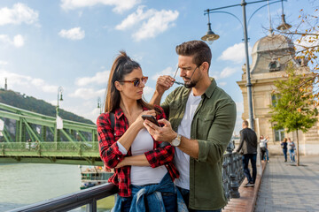 A couple arguing over the content on the mobile phone screen