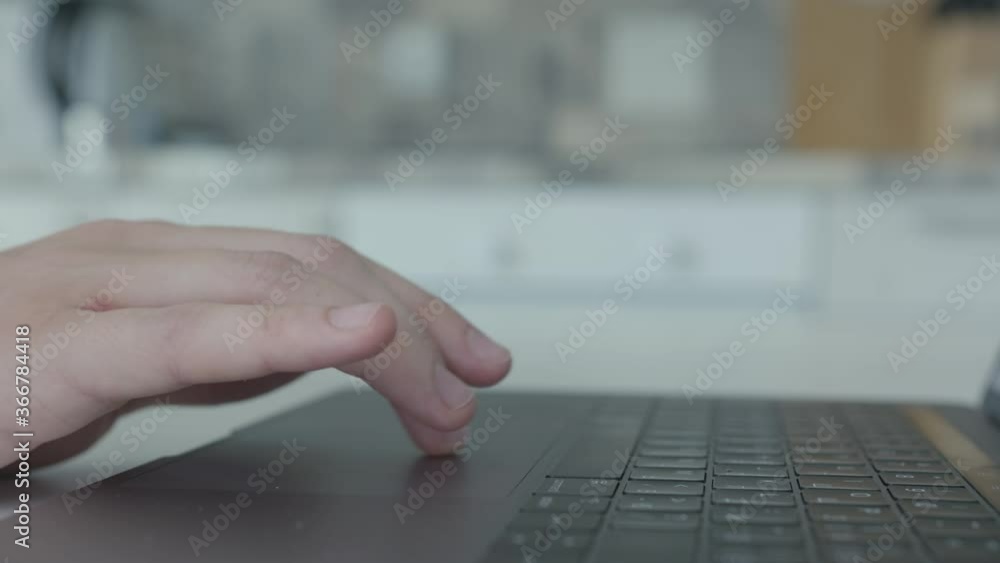 Poster close-up of man clicking on keyboard mouse of laptop. action. men's fingers move along touch panel o