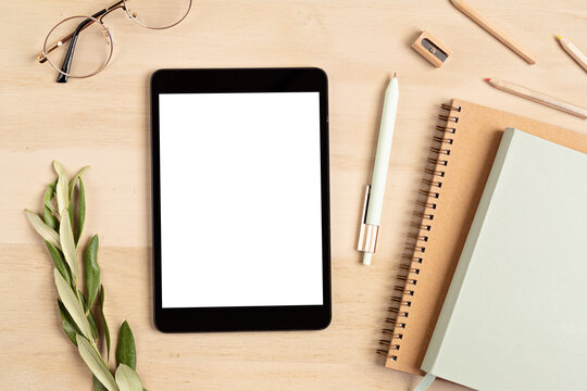 Styled minimal desktop mockup with organic color stationary, digital tablet, notepad. Freelancer, social media blogger concept. Flat lay, top view, copy space.