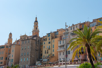 Residential buildings and church tower by the promenade. Menton, south of France. 