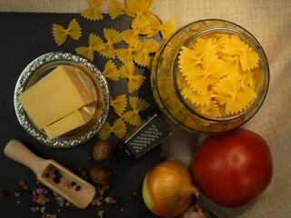 Butterfly pasta with spices in a glass jar