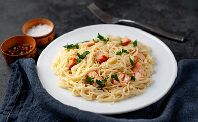 
pasta with salmon on a stone background