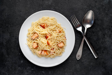 
pasta with salmon on a stone background