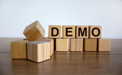 Concept word 'demo' on cubes on a beautiful wooden table. White background. Business concept. Copy...