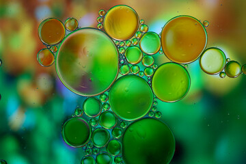 Abstract background with vibrant colours. Oil drops in water. Close colorful and artistic bubbles. Space pattern.