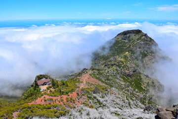 Fototapeta na wymiar Madeiran landscape with high mountains, a trail and Casa de Abrigo. Portugal.