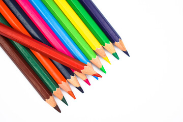 A red color wood pencil crayon placed on top of a row of different color wood pencil